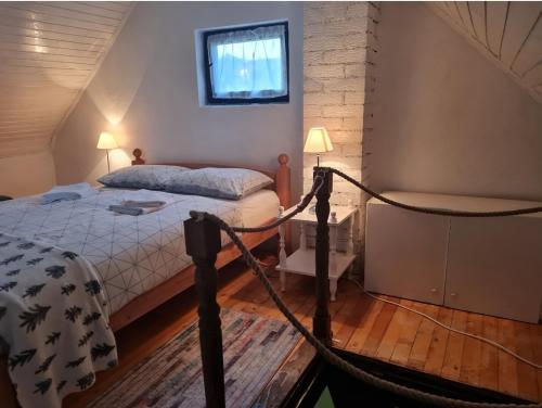 a bedroom with a bed and a hammock in it at Vikendica Alisa in Doboj