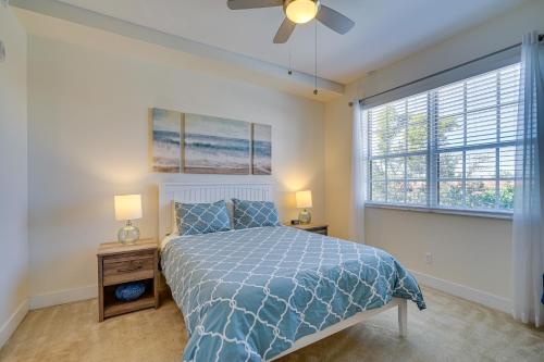 a bedroom with a bed and two lamps and a window at Modern Fort Myers Condo Rental about 5 Mi to Beach! in Fort Myers