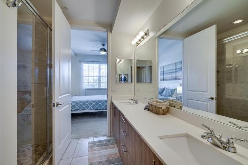 a bathroom with two sinks and a large mirror at Modern Fort Myers Condo Rental about 5 Mi to Beach! in Fort Myers