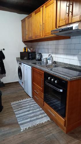 a kitchen with a sink and a dishwasher at Casa do Freire - Serra da Estrela in Aguincho