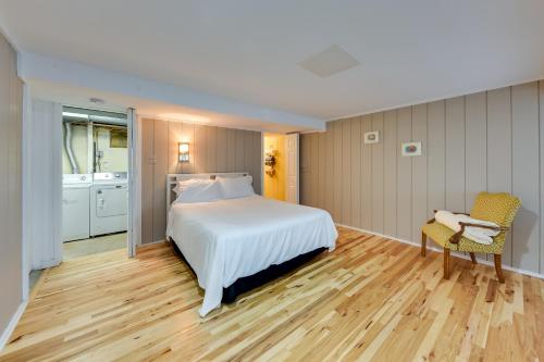 een slaapkamer met een wit bed en een stoel bij Salem Vacation Home with Dock Steps to Paddock Lake in Twin Lakes