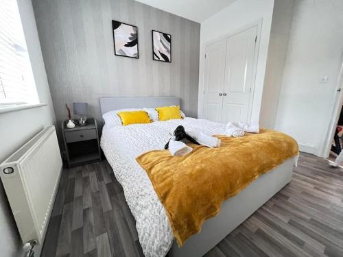 a bedroom with a bed with a cat laying on it at Ava's Apartment - 1 Bedroom In Solihull Centre - Free Parking - Wi-Fi in Solihull
