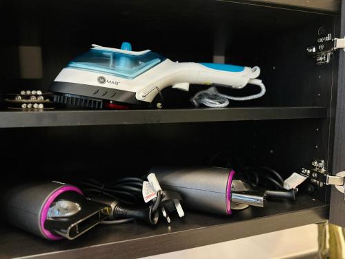 a shelf with a sewing machine on top of it at New 2BR or 3BR Cozy Urban Suite Homestay at Georgetown8-10pax by URBAN STAYCATIONS LOD in Jelutong