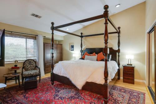 a bedroom with a large bed and a rug at Deluxe Townhome with Deck, 2 Mi to Downtown Modesto! in Modesto