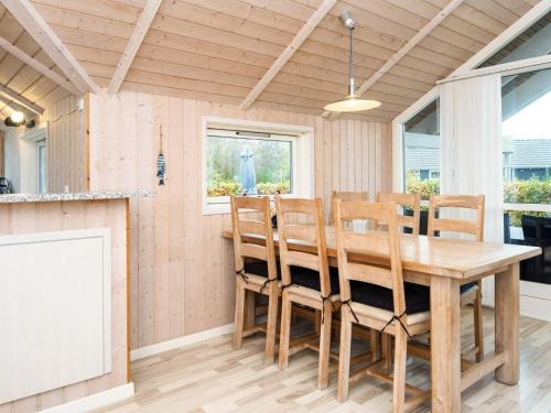 a dining room with a wooden table and chairs at 4 star holiday home in Sydals-By Traum in Neder Lysabild