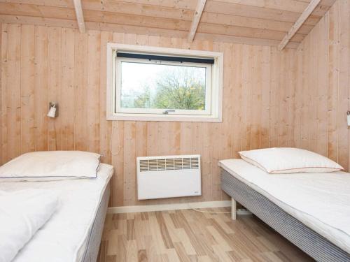 two beds in a room with a window at 4 star holiday home in Sydals-By Traum in Neder Lysabild
