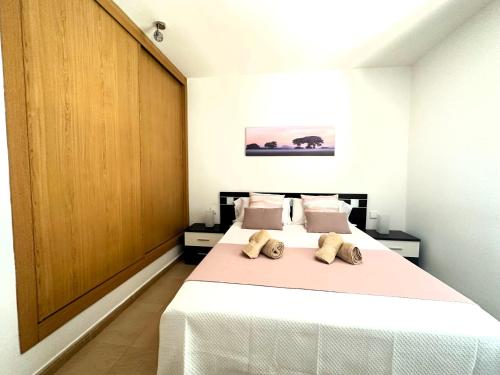 a bedroom with a bed with two teddy bears on it at Casa La Olas in Morro del Jable