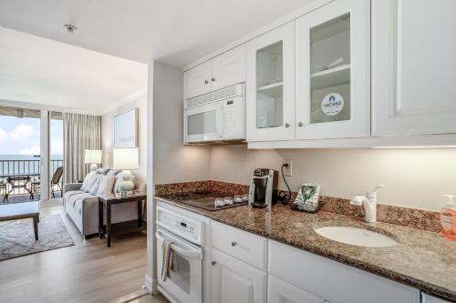 a kitchen with a sink and a counter top at Marco Beach Ocean Resort 1102 in Marco Island