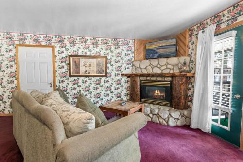 a living room with a couch and a fireplace at Black Forest Lodge in Big Bear Lake