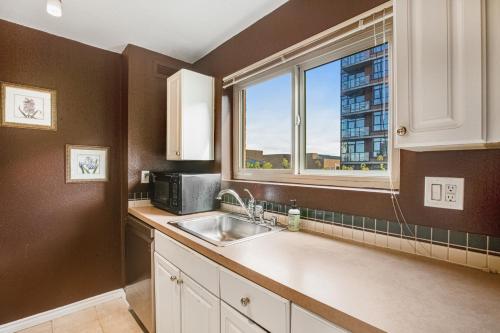 a kitchen with a sink and a window at Central Respite in Seattle