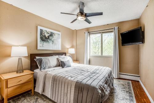 a bedroom with a bed and a ceiling fan at Central Respite in Seattle