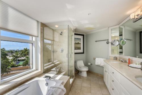 a bathroom with a sink and a toilet and a window at Marco Beach Ocean Resort 714 in Marco Island