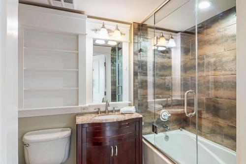 a bathroom with a toilet and a sink and a shower at The Grand #2611 in Destin