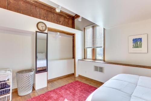 a bedroom with a bed and a window and a clock at Chagrin Falls Home about 2 Mi to Town! in Chagrin Falls