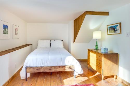 a bedroom with a white bed and a wooden dresser at Cozy Chagrin Falls Retreat 2 Mi to Town! in Chagrin Falls