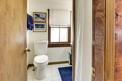 a bathroom with a toilet and a window at Cozy Chagrin Falls Retreat 2 Mi to Town! in Chagrin Falls
