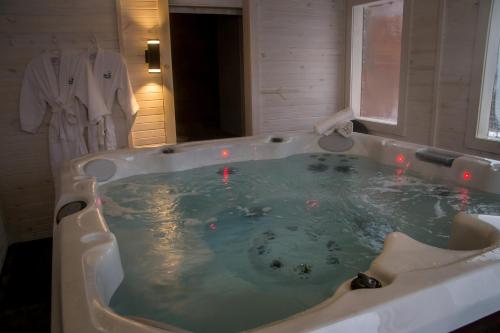 a jacuzzi tub with red lights in a bathroom at Centre de Vacances 5 Étoiles Family Resort in Sacré-Coeur-Saguenay