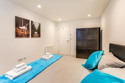 a bedroom with a blue bed and a closet at Exceptionally Spacious Central Canterbury Home in Canterbury