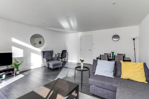 a living room with a couch and a tv at Exceptionally Spacious Central Canterbury Home in Canterbury