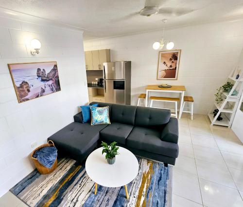 a living room with a couch and a table at Bakers Sea Breeze Escape in North Ward