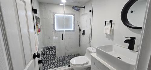 a bathroom with a shower and a toilet and a sink at Private Cozy & Spacious Room at a house with pool in Tamarac
