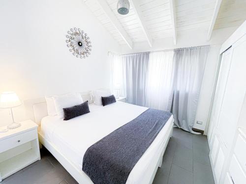 a white bedroom with a white bed and a window at OCEAN & GARDEN View WIFI BBQ Beach CLUB & SPA in Punta Cana