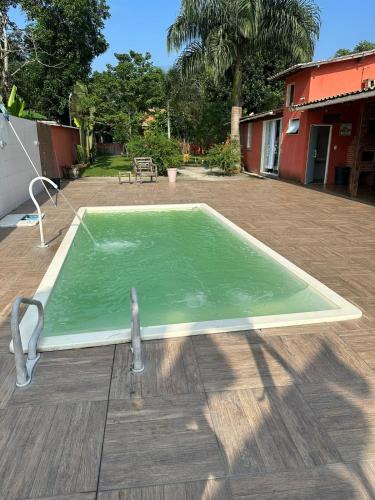 uma pequena piscina de água verde num quintal em Chácara de Alto Padrão em Nova Iguaçu