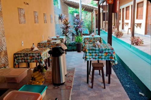 a restaurant with two tables and a trash can at Pousada Vila Alter in Alter do Chao