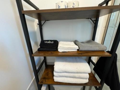 a shelf with towels on it in a bathroom at Cartagena Room in Seattle