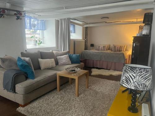a living room with a couch and a bed at Independent apartment in Borås in Borås