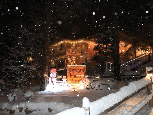 a santa claus sign in the snow in front of a hotel at Sheridan House Inn- Adult Only Accommodation in Williams