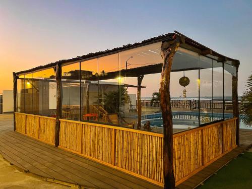 a large building with glass windows on a deck at Aloha Lobitos in Lobitos