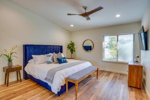 a bedroom with a blue bed and a ceiling fan at 1 Mi to State Beach! Dog-Friendly Dana Point Condo in Dana Point