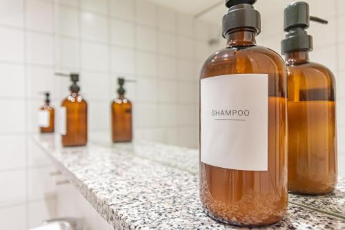 a bottle of shampoo sitting on a counter in a bathroom at Dockside Penthouse Albert in Liverpool