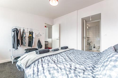 a bedroom with a blue and white bed and a closet at Dockside Penthouse Albert in Liverpool