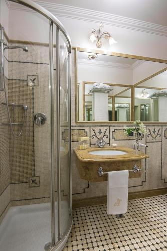 a bathroom with a sink and a glass shower at Liberty Hotel in Catania