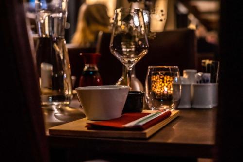 a table with a coffee cup and a wine glass at Radisson Blu Resort, Beitostølen in Beitostøl