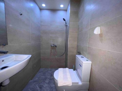 a bathroom with a shower and a toilet and a sink at Agadir Suite in Agadir