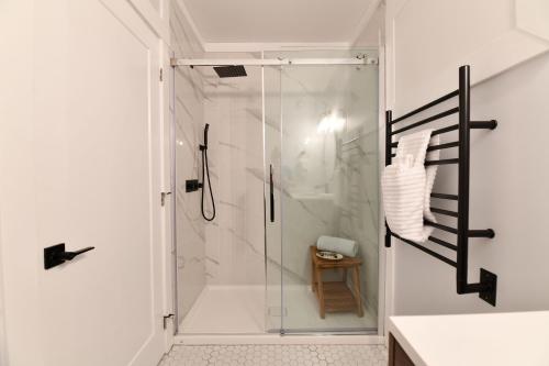 a bathroom with a shower with a glass door at Jardin Suites Highfield in Moncton