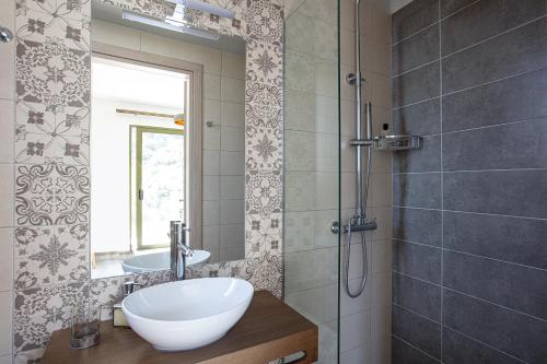 a bathroom with a sink and a shower at Aléa Villa Plakias in Plakias
