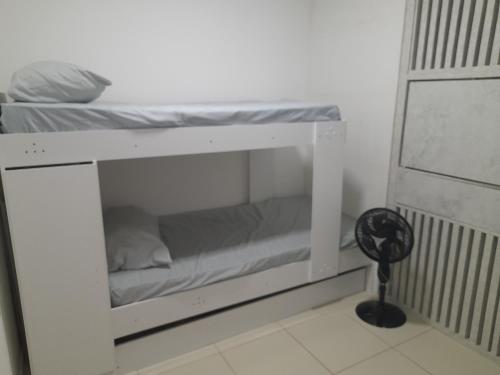 a white bunk bed in a room with a fan at Apartamento flat em condomínio club in Aracaju