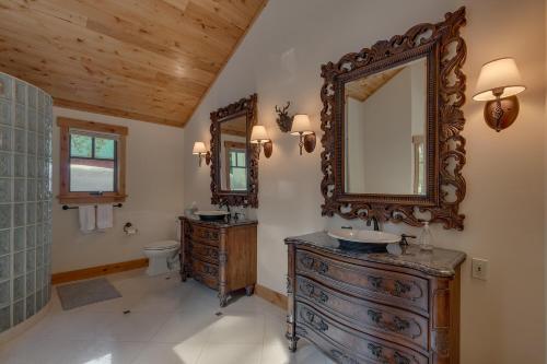 a bathroom with two sinks and a large mirror at Majestic Woods at Tahoe Donner - High End Craftsman w Game Room, Hot Tub, Amenity Access in Truckee