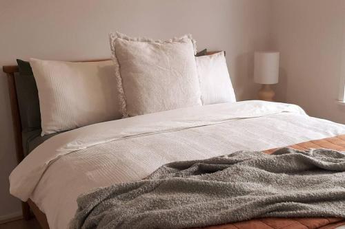 a bedroom with a bed with a blanket on it at Spacious Unit in Convenient Location in Yarrawonga