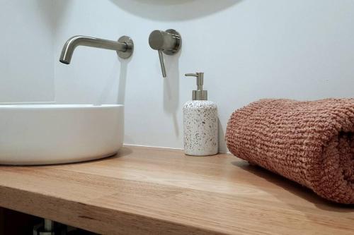a bathroom counter with a sink and a soap dispenser at Spacious Unit in Convenient Location in Yarrawonga
