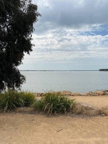 a view of a body of water with a tree at Spacious Unit in Convenient Location in Yarrawonga