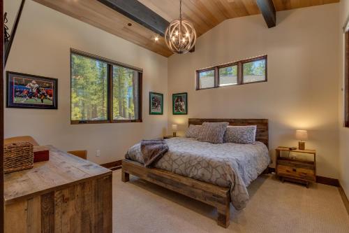 una camera da letto con un letto, un tavolo e finestre di Sage Hen at Grays Crossing - Gorgeous 4BR 4BA Home w Private Hot Tub a Truckee