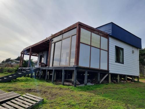 a house on a dock with glass at Casa Curanipe in Curanipe