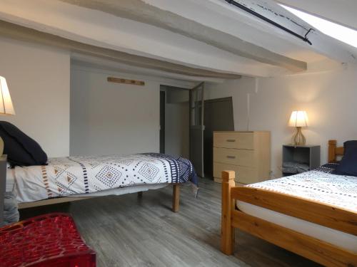 a bedroom with two beds and a dresser at Élégante maison de ville avec cour intérieure, centre de Châteaudun, proche sites touristiques - FR-1-581-115 in Châteaudun