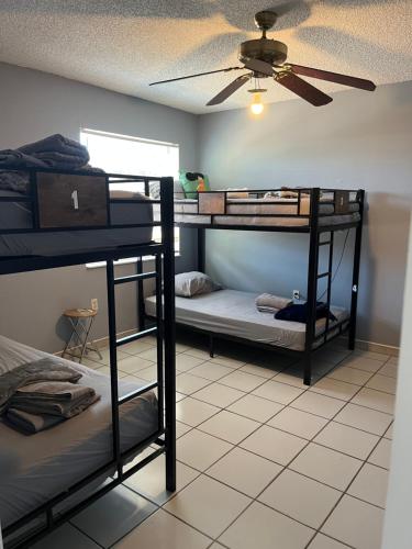a room with three bunk beds and a ceiling at Beds & Sheets Little Havana in Miami