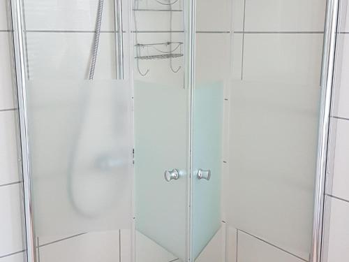 a shower with a glass door in a bathroom at Apartment in Bissendorf near Osnabrück in Bissendorf
